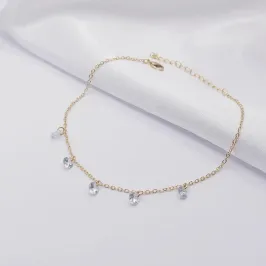 TORNOZELEIRA DOURADA COM CINCO PONTOS DE LUZ CRISTAL