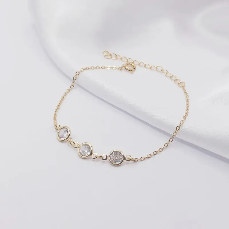 PULSEIRA DOURADA COM TRIPLO PONTO DE LUZ CRISTAL