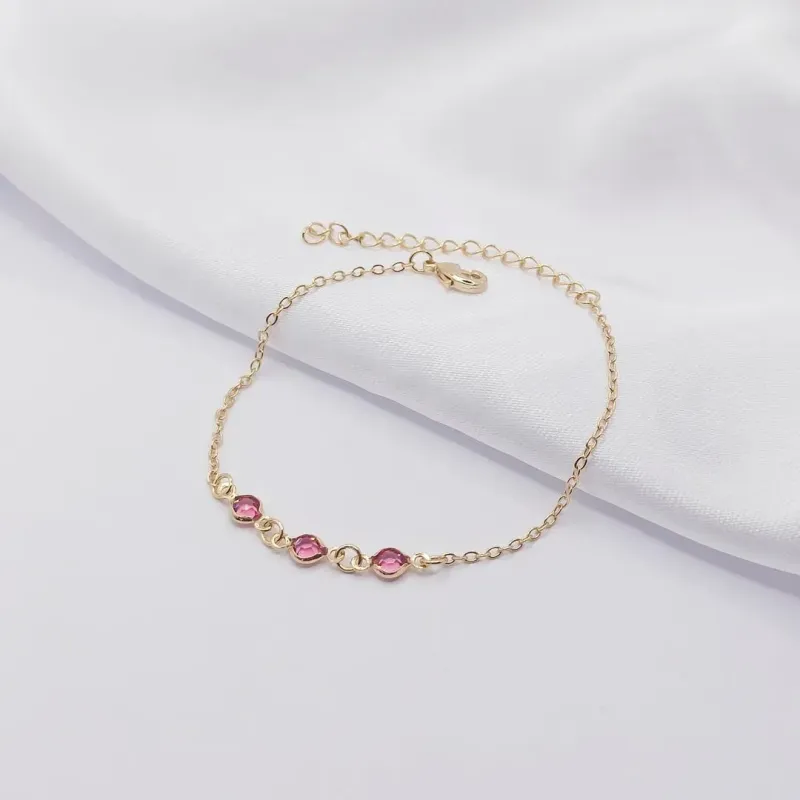 PULSEIRA DOURADA COM TRIPLO PONTO DE LUZ ROSA