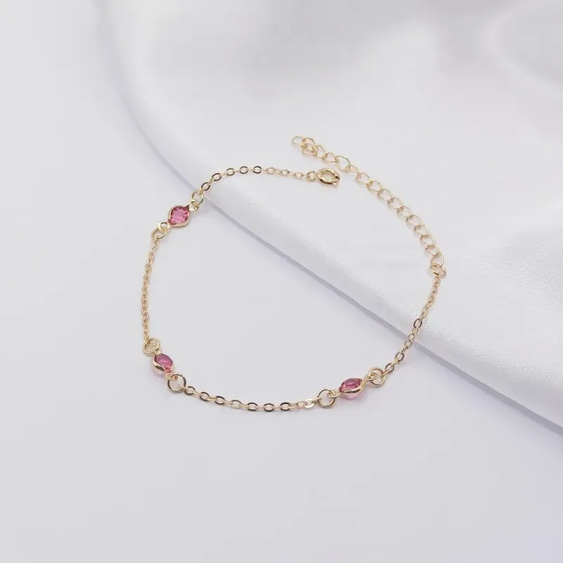 PULSEIRA DOURADA INFANTIL COM TRÊS PONTOS DE LUZ ROSA