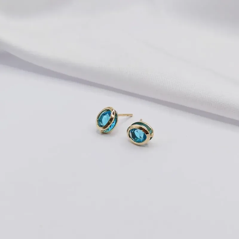 BRINCO DOURADO PONTO DE LUZ OVAL AZUL