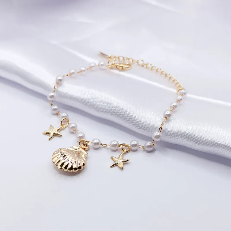 PULSEIRA DOURADA ELO DE PÉROLA COM CONCHA E ESTRELA DO MAR
