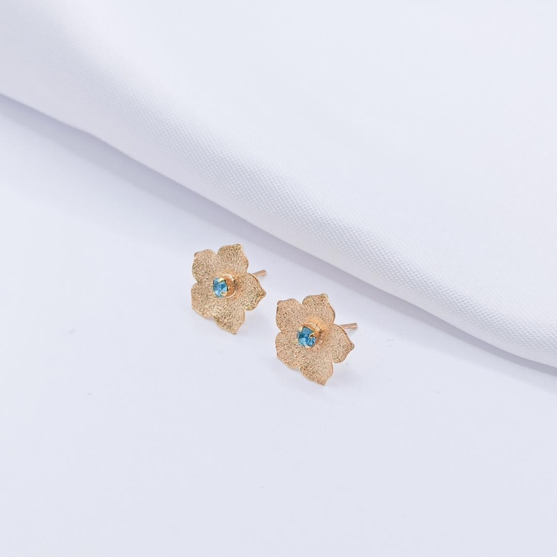 BRINCO DOURADO FLOR COM PONTO DE LUZ AZUL G