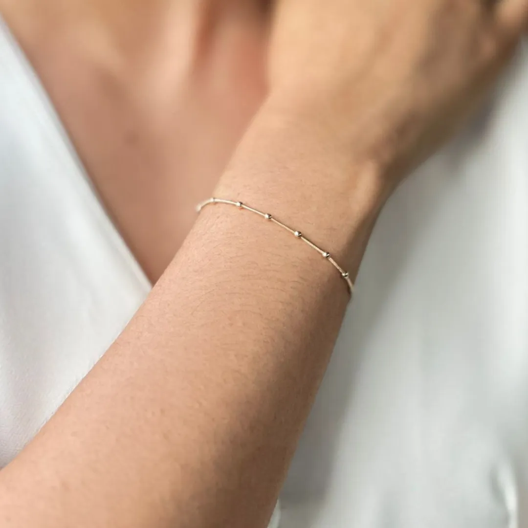 PULSEIRA DOURADA FINA BOLINHAS