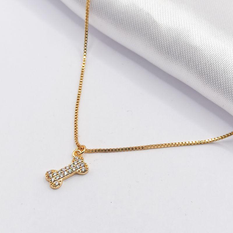 GARGANTILHA DOURADA CHOKER OSSINHO CRAVEJADO 35CM